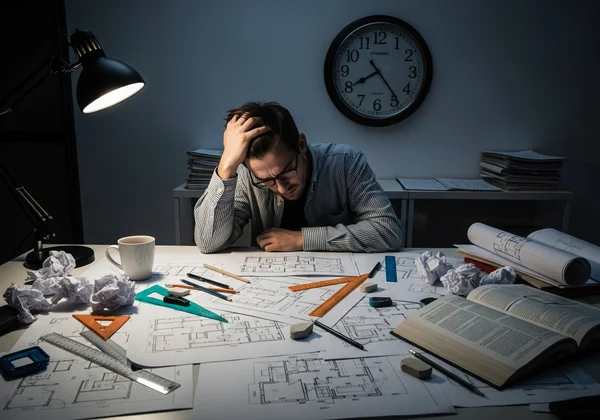 Stressed architect with manual floor plan revisions